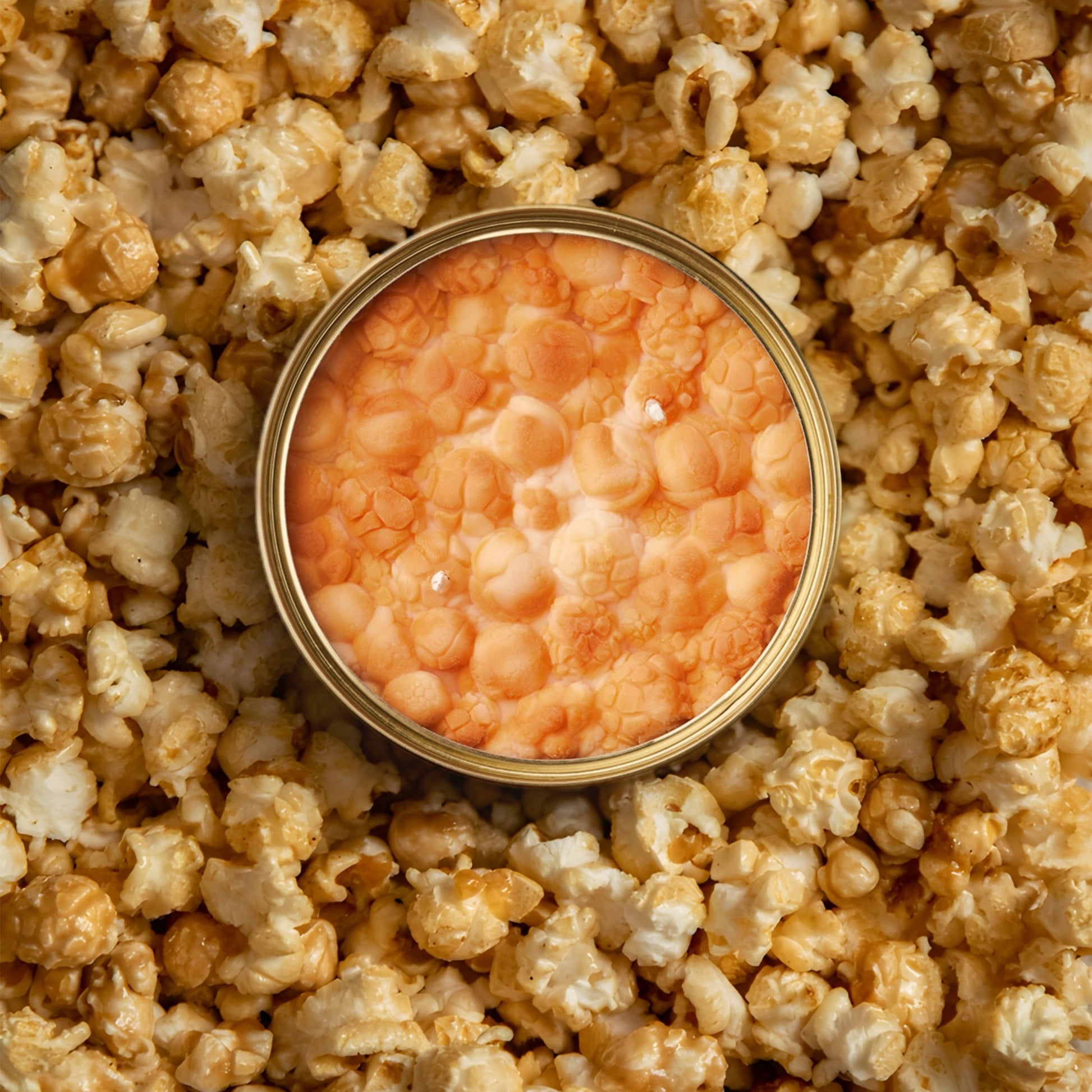 caramel popcorn scented candle in a gold tin 