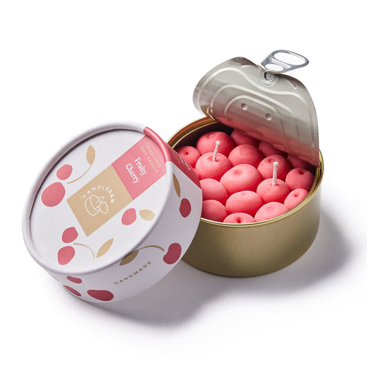 cherry shaped scented candle in a gold tin 
