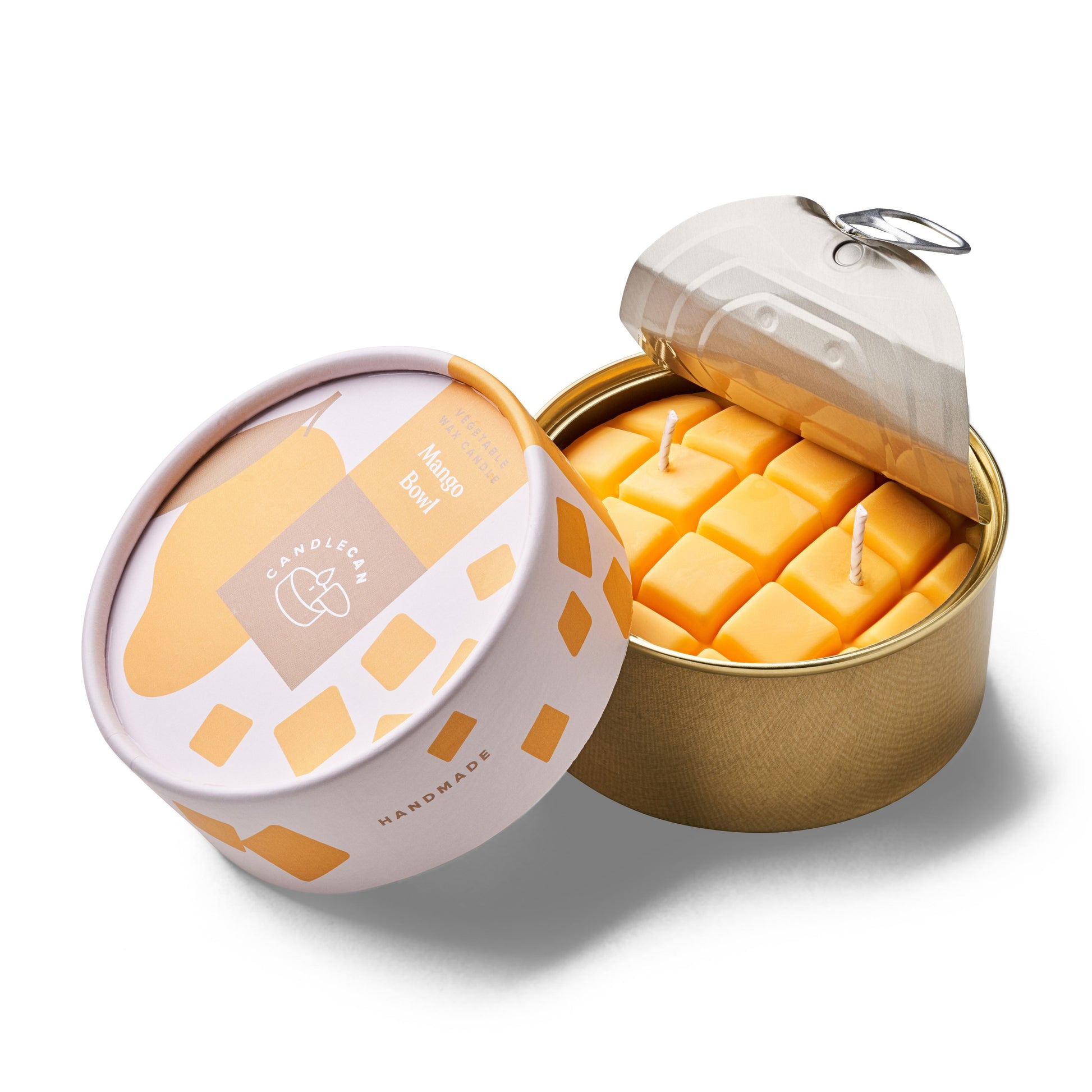 mango shaped scented candle in a gold tin 