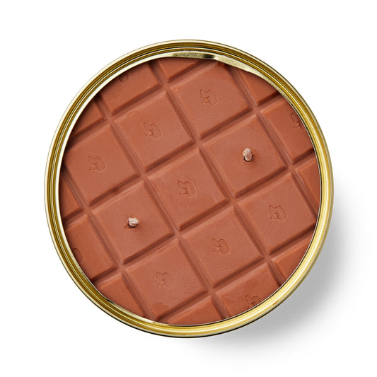 chocolate shaped candle in a gold tin on a white background